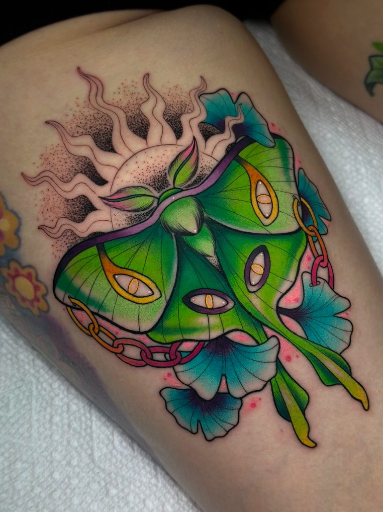 Luna moth and sun tattoo on the thigh by Tia Berry, colour tattoo artist in Vancouver
